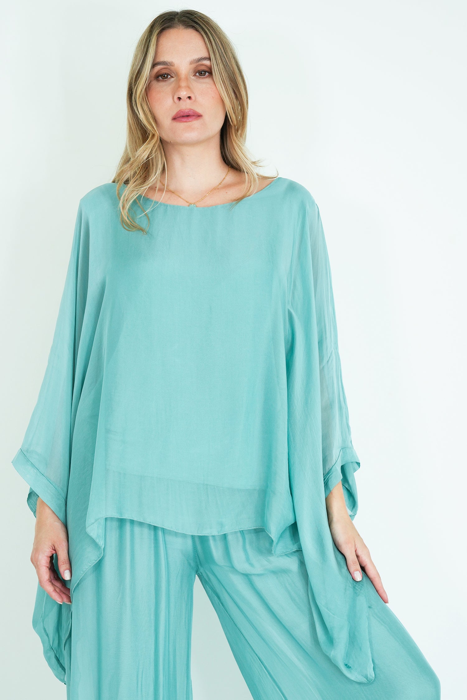 Woman wearing a light blue outfit on a white background