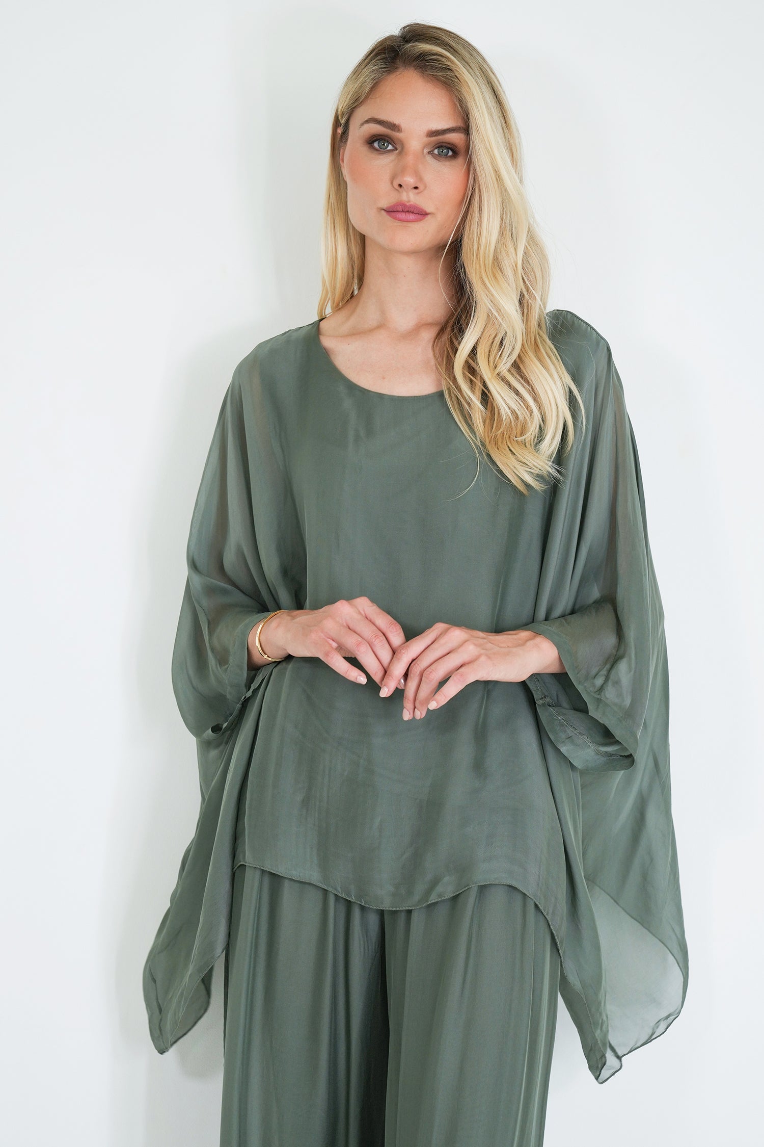 Woman wearing a green dress against a white background