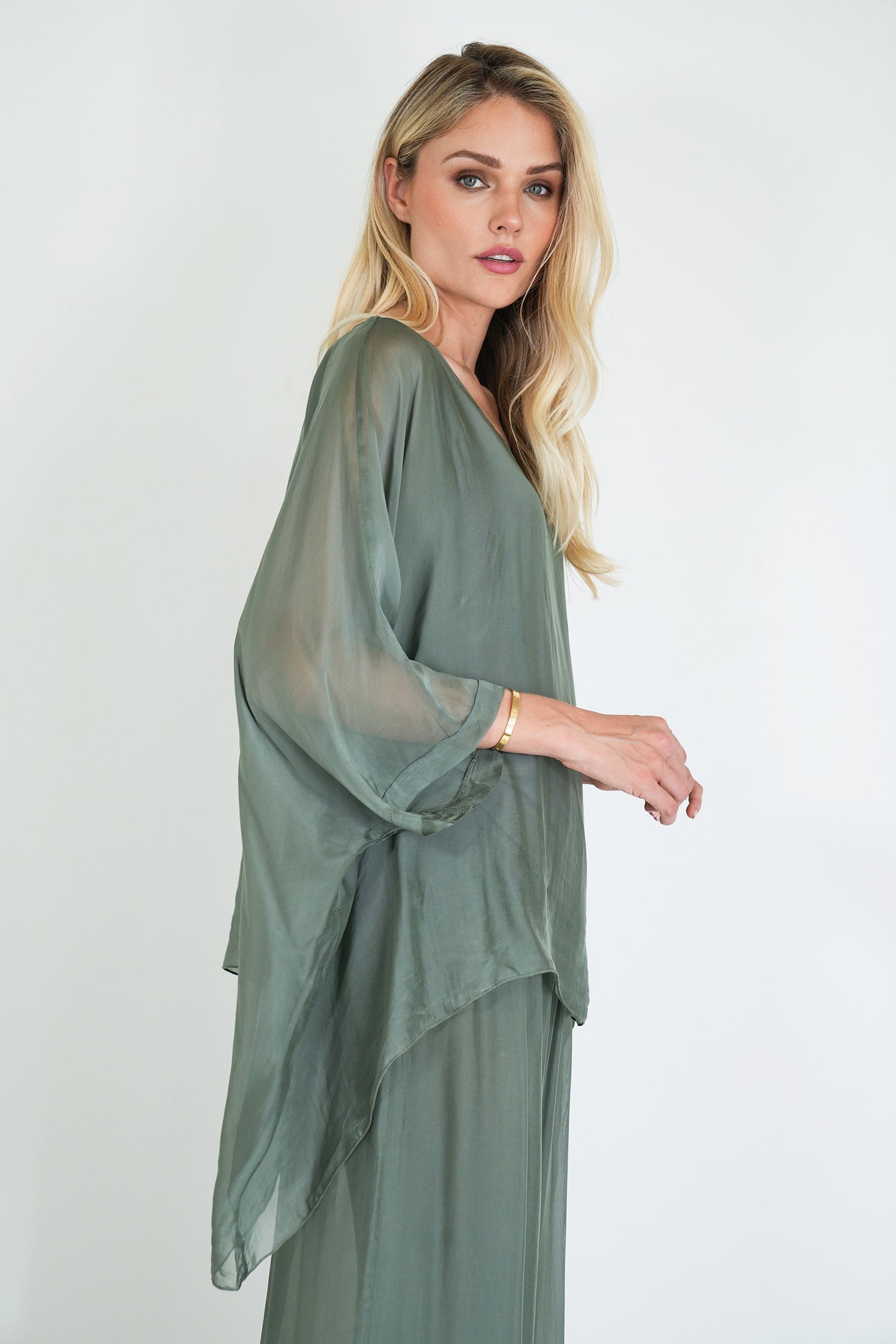 Woman wearing a green dress against a white background