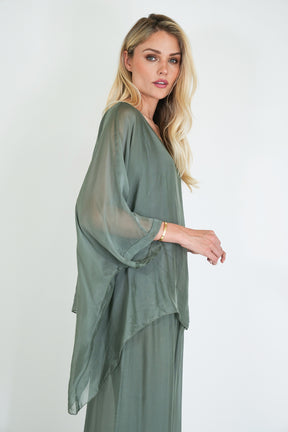 Woman wearing a green dress against a white background