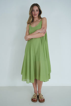 Woman wearing a green dress against a white background