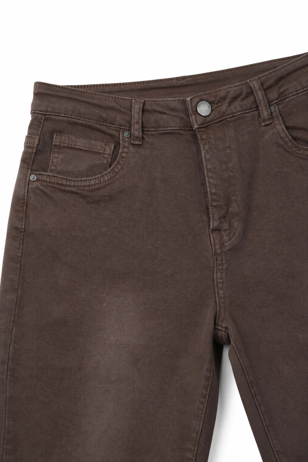 Close-up of dark brown denim jeans showing the waistband, belt loops, button, front pocket, and leg area on a white background.