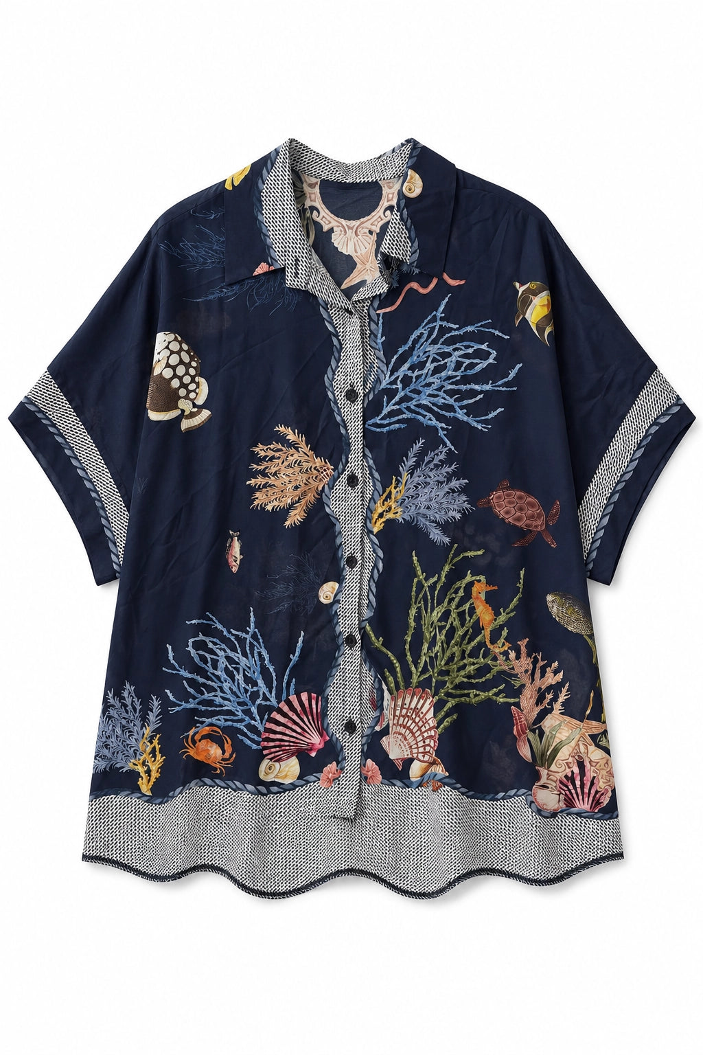 A short-sleeve button-up shirt in navy blue with an all-over embroidered underwater scene, featuring seashells, coral, fish, and sea urchins in various colors, displayed flat against a white background.