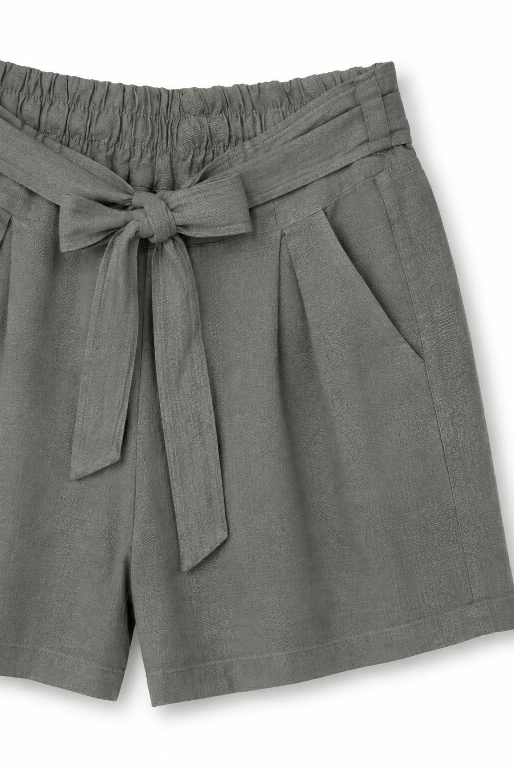 A close-up of gray linen-blend shorts featuring an elastic waistband, a matching fabric tie belt knotted at the front, and side pockets, set against a plain white background.
