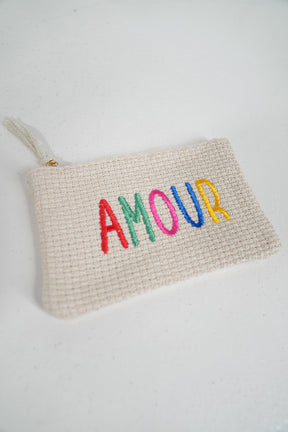 Woven pouch with 'AMOUR' in colorful letters on a white background