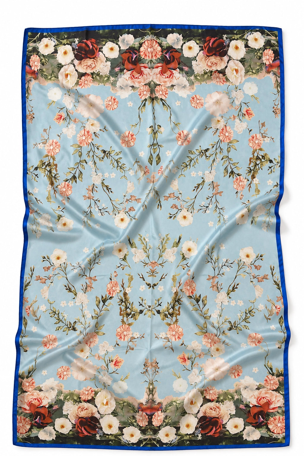A square silk scarf featuring a light blue background with a symmetrical floral pattern and a dark blue border, laid flat with soft folds.