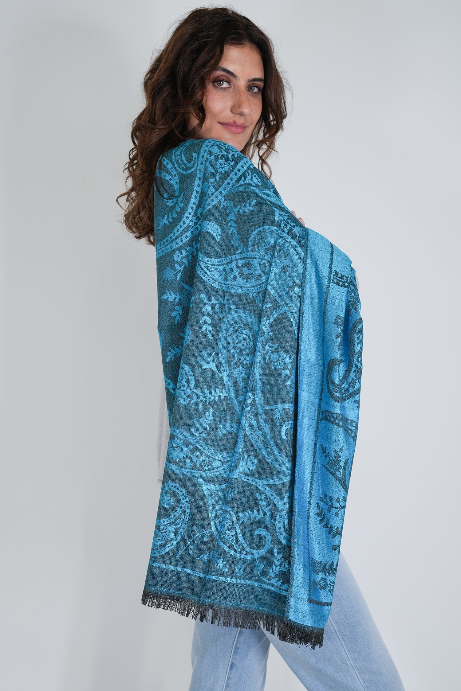 Woman wearing a blue patterned scarf on a white background