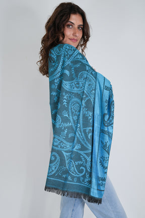 Woman wearing a blue patterned scarf on a white background