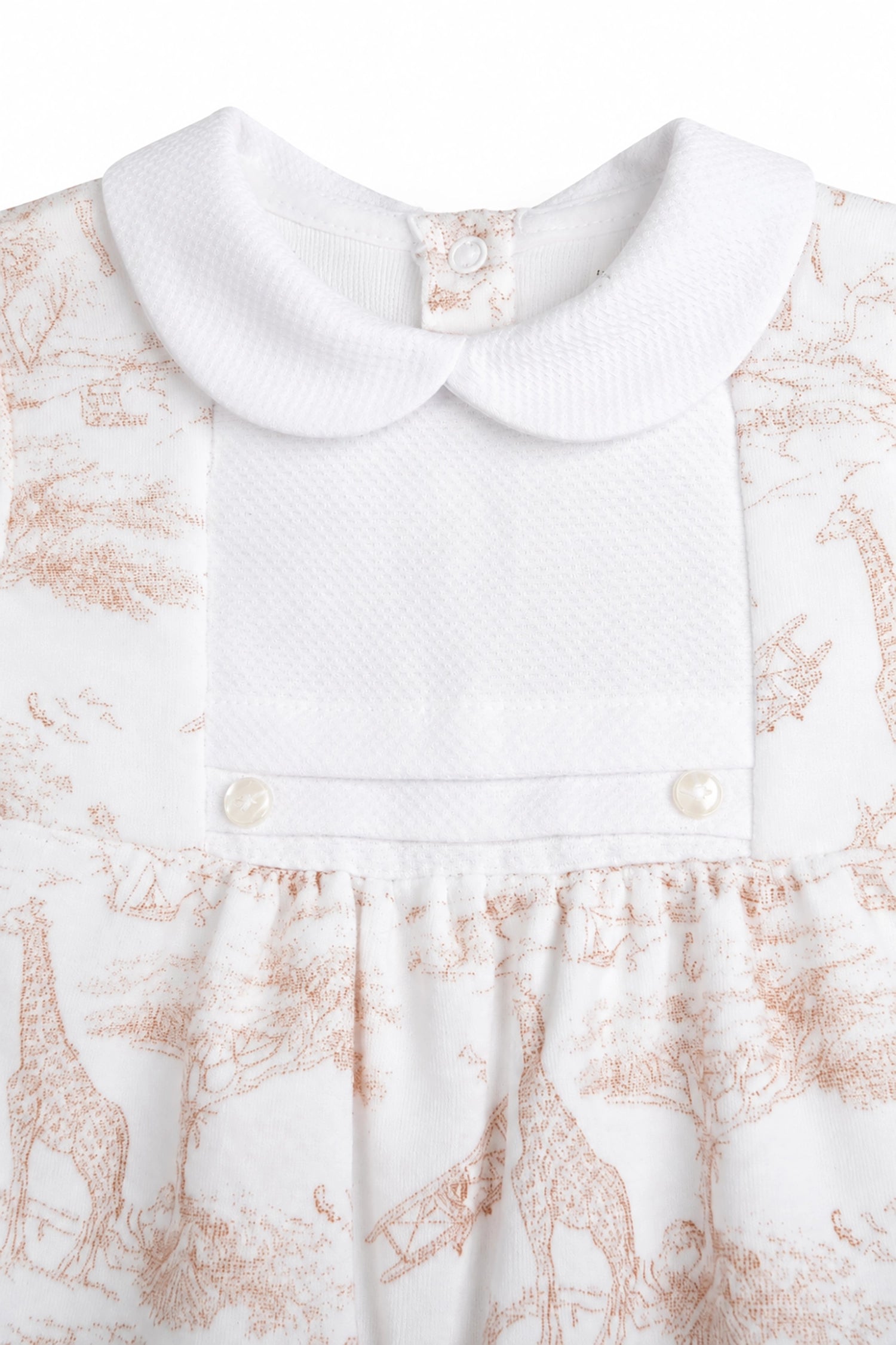 Close-up of a white dress with a floral pattern on a white background