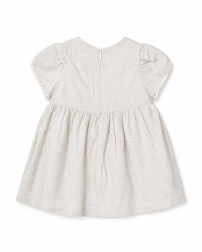 White baby dress with ruffled sleeves on a white background