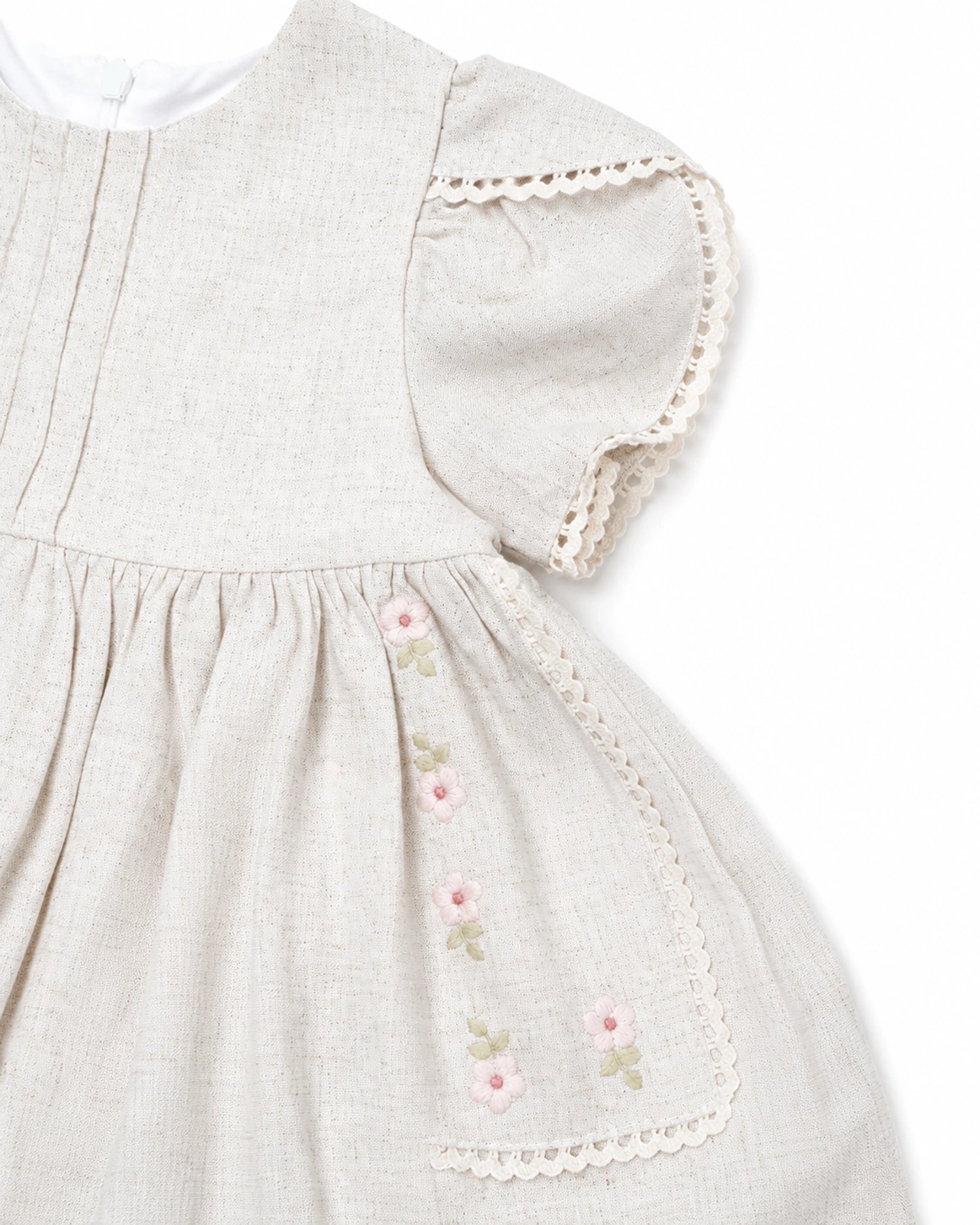 Light gray dress with floral embroidery and lace trim on a white background