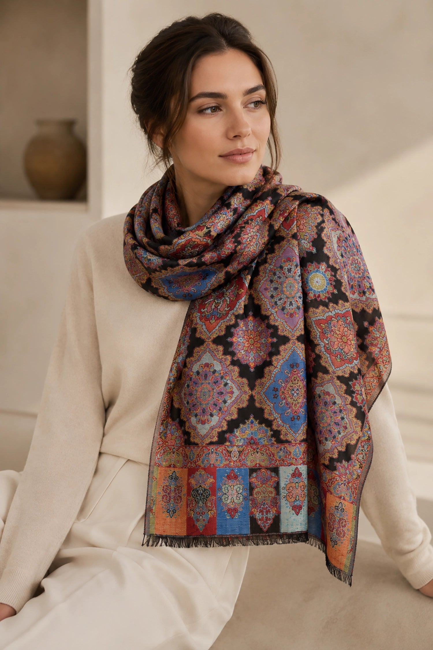 Woman wearing a patterned scarf in an indoor setting