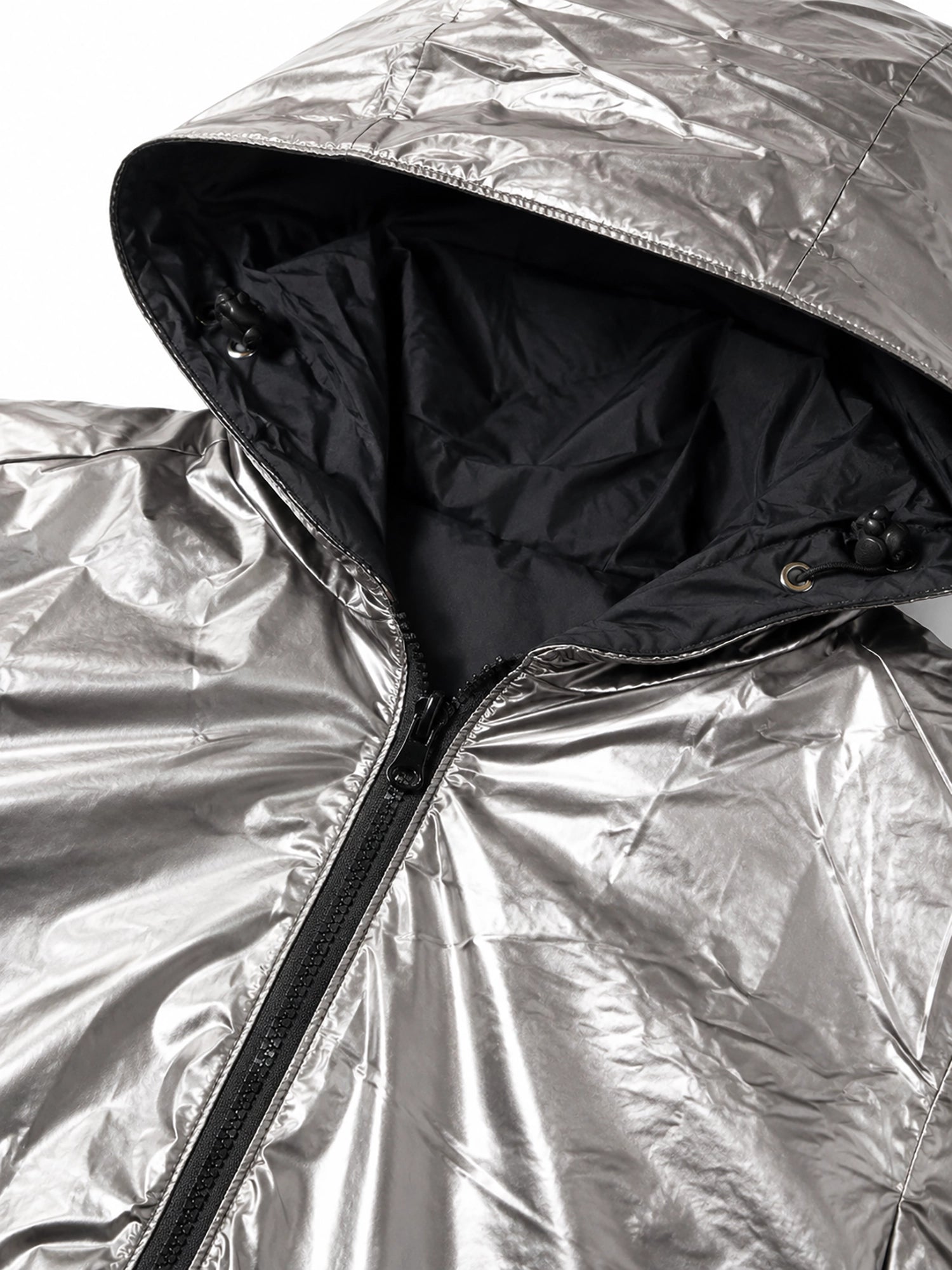 Close-up of a silver reflective jacket with a hood.