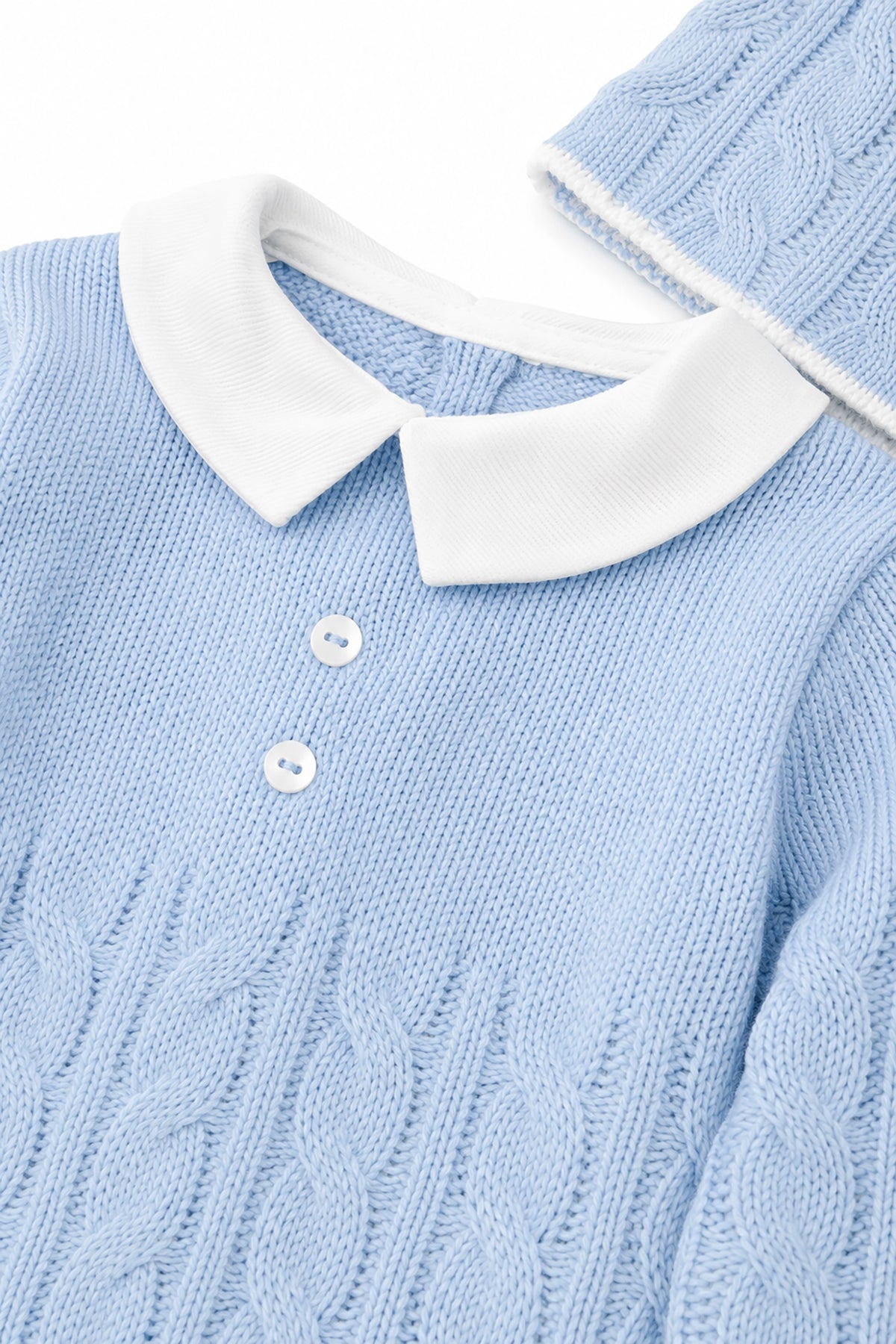 Light blue sweater with white collar and buttons on a white background