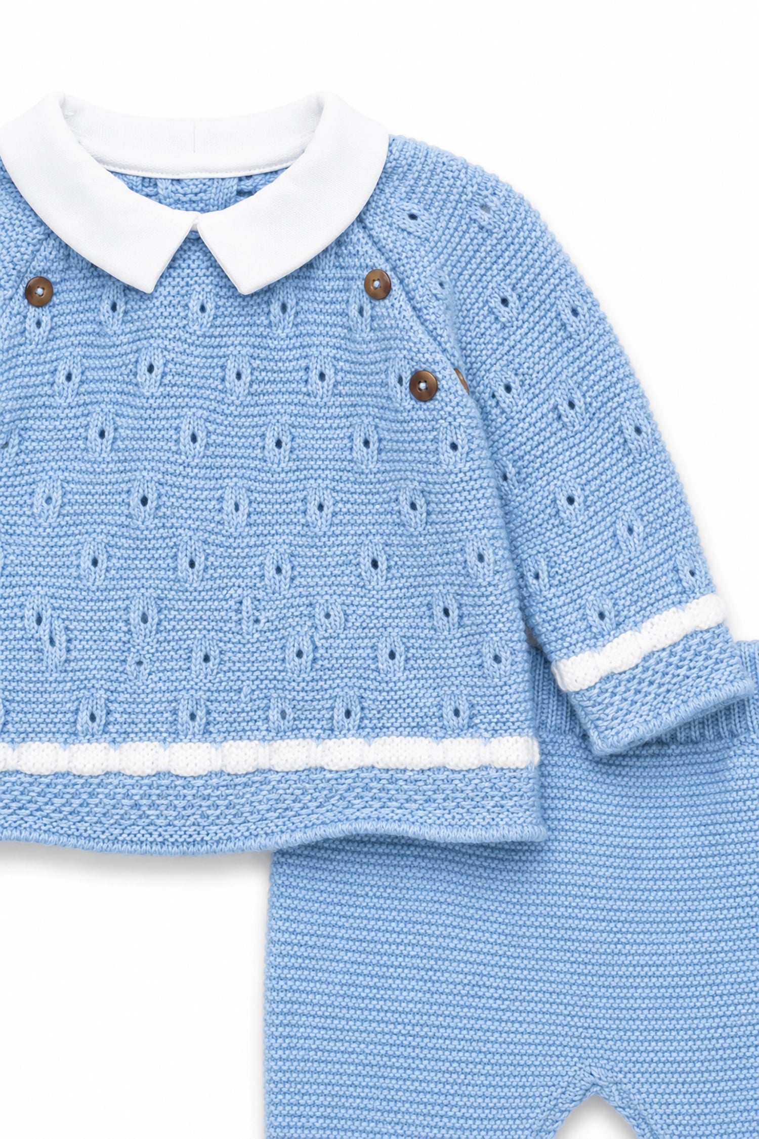 Blue knitted baby outfit with white collar and buttons on a white background