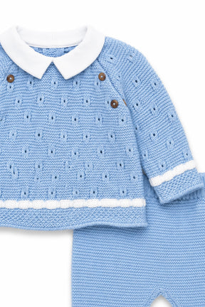 Blue knitted baby outfit with white collar and buttons on a white background