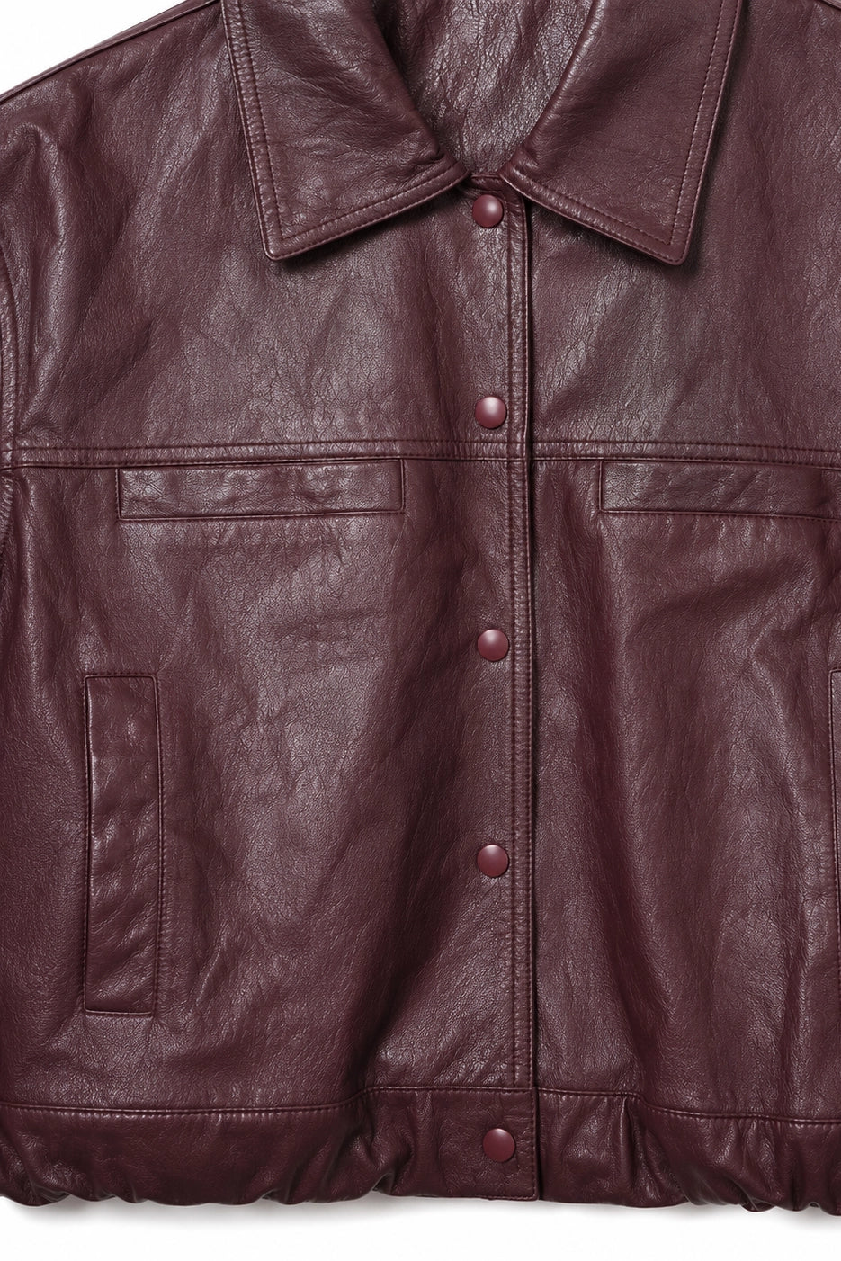 Close-up of a burgundy pleather jacket with buttons on a white background