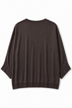 A dark brown long-sleeve top with a relaxed, oversized fit, displayed flat against a plain white background.