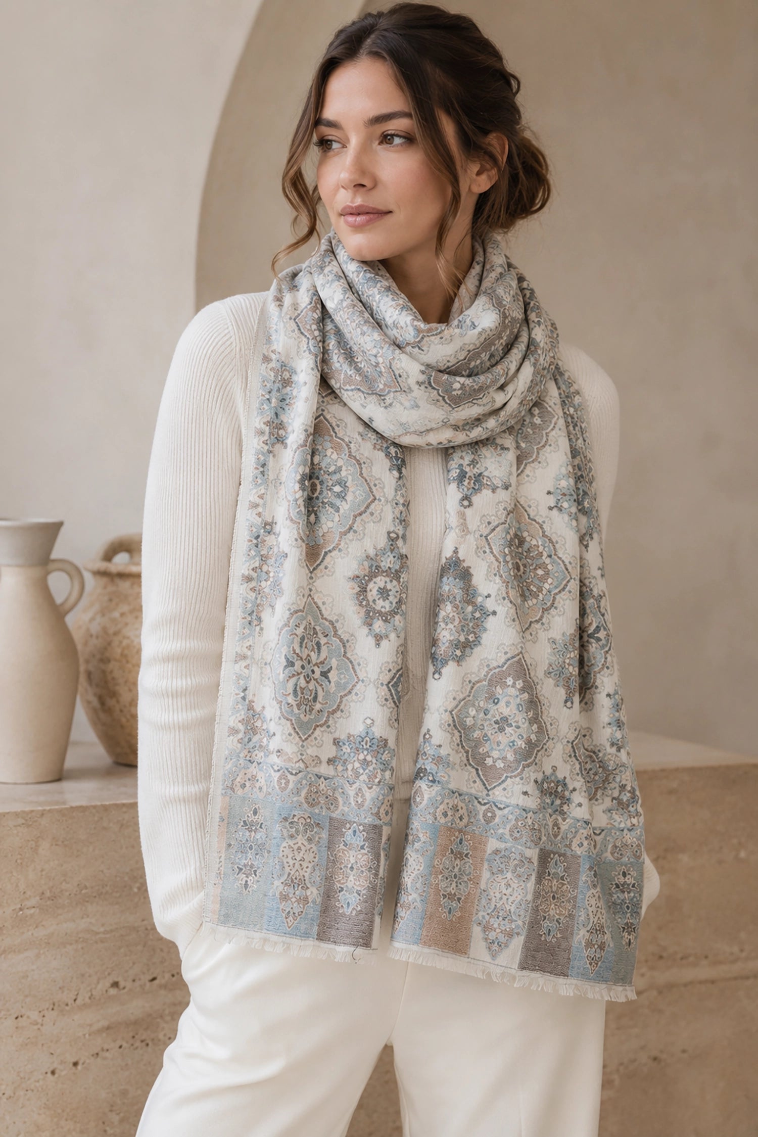 Woman wearing a patterned scarf in a neutral setting