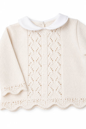 Knitted sweater with lace details on a white background