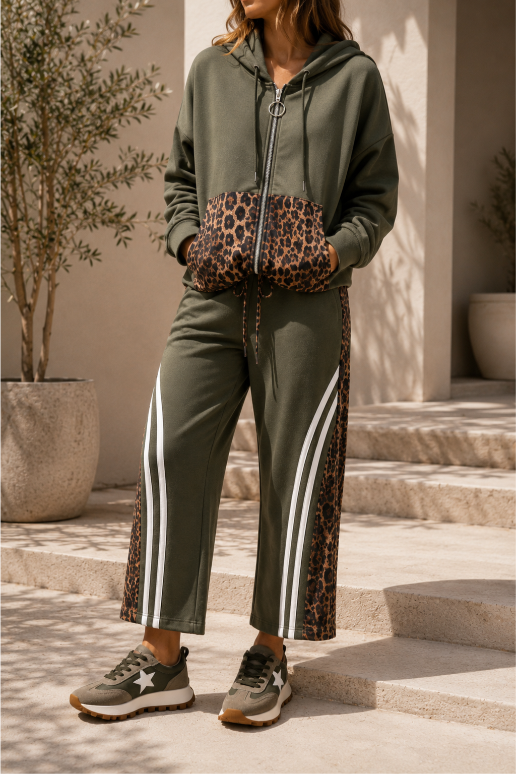 Person wearing a green tracksuit with leopard print accents outdoors.
