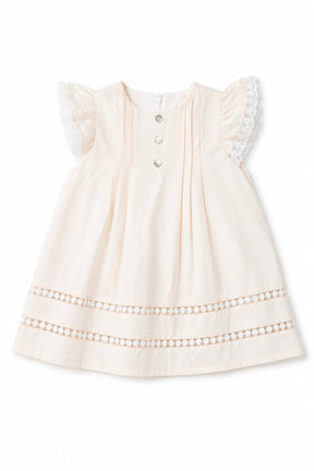 White baby dress with lace details on a white background