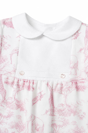White dress with pink floral pattern and pearl buttons on a white background