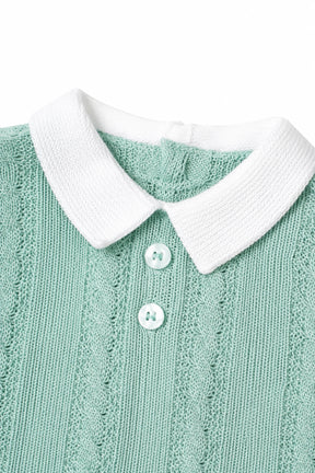 Green knitted sweater with white collar and buttons on a white background