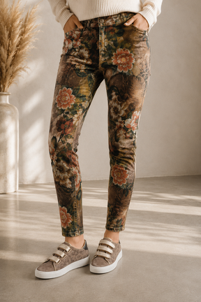Person wearing floral-patterned pants with a neutral background